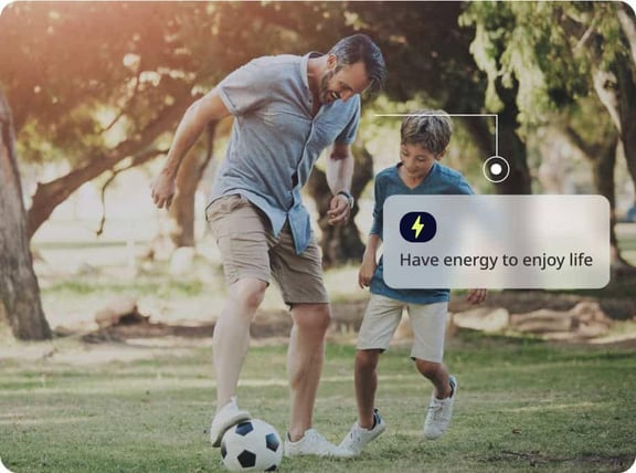 dad playing soccer with son 