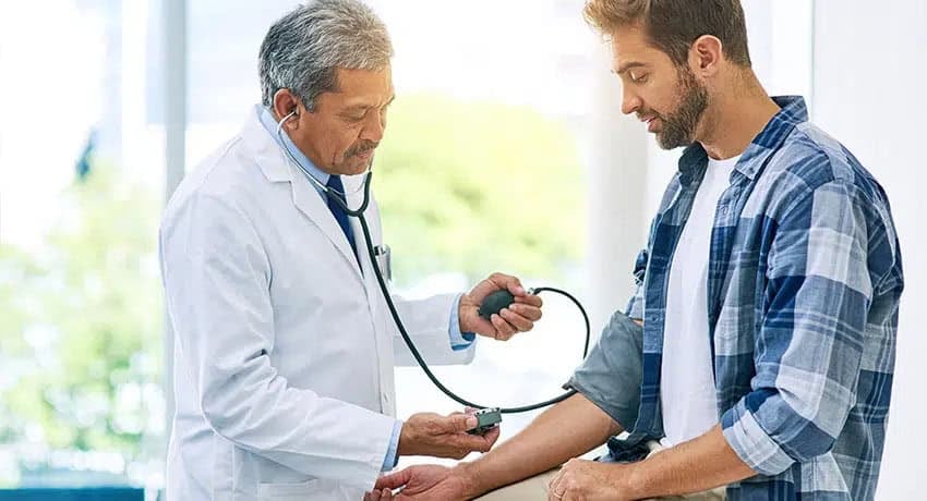 doctor checking patient blood pressure