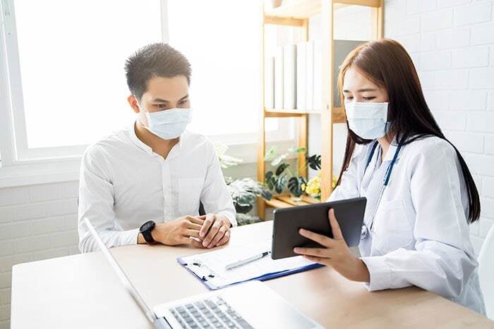 doctor consulting patient using digital tablet