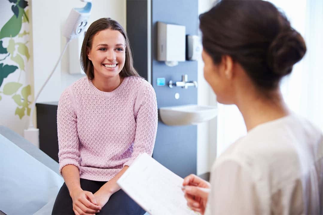 female patient smiling during medical consultation