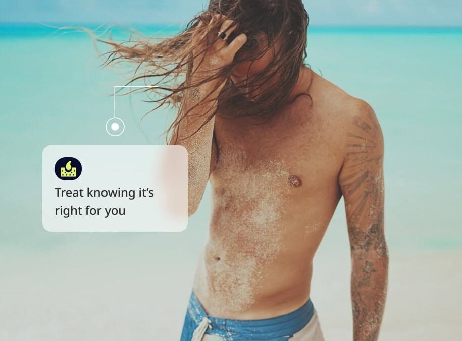 man with long hair on beach
