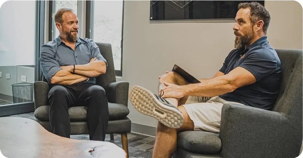 men sitting in office talking