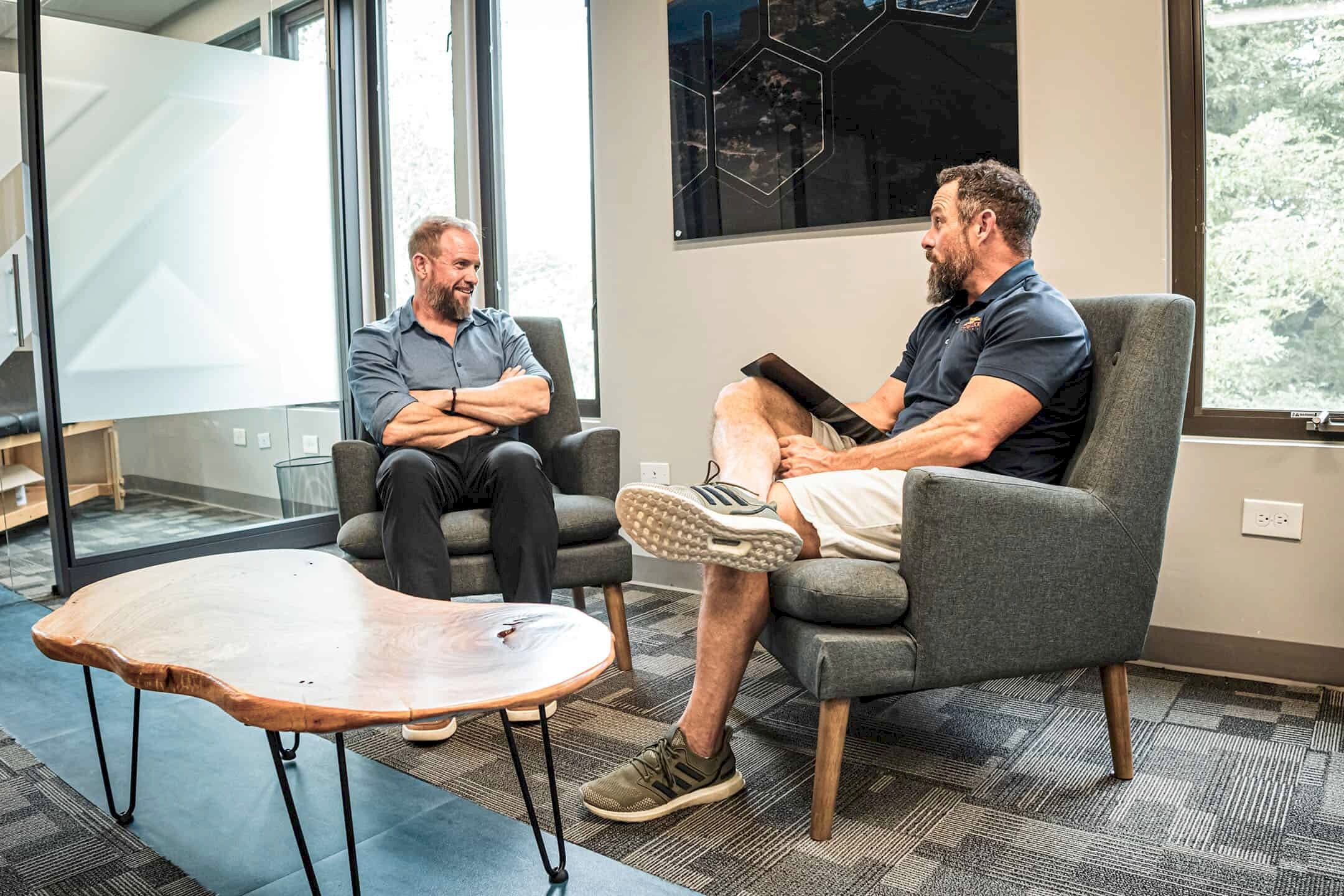 two men discussing hormone health treatment