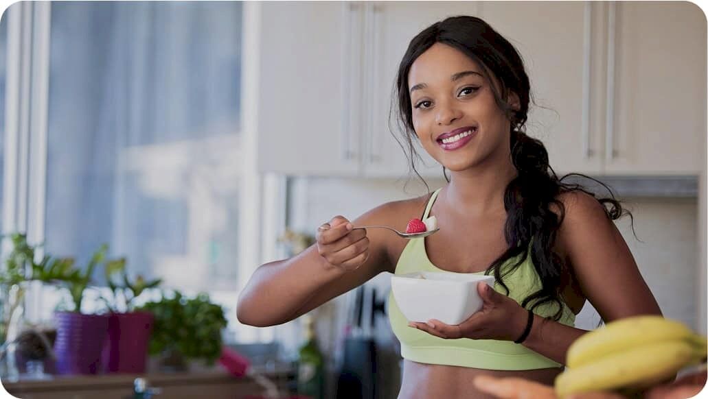 women eating healthy meal with spoon