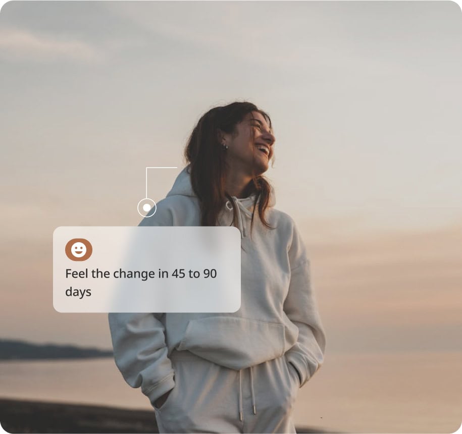 A smiling person in a white hoodie stands outdoors at sunset, with text overlay: Feel the change in 45 to 90 days and a smiley face icon.